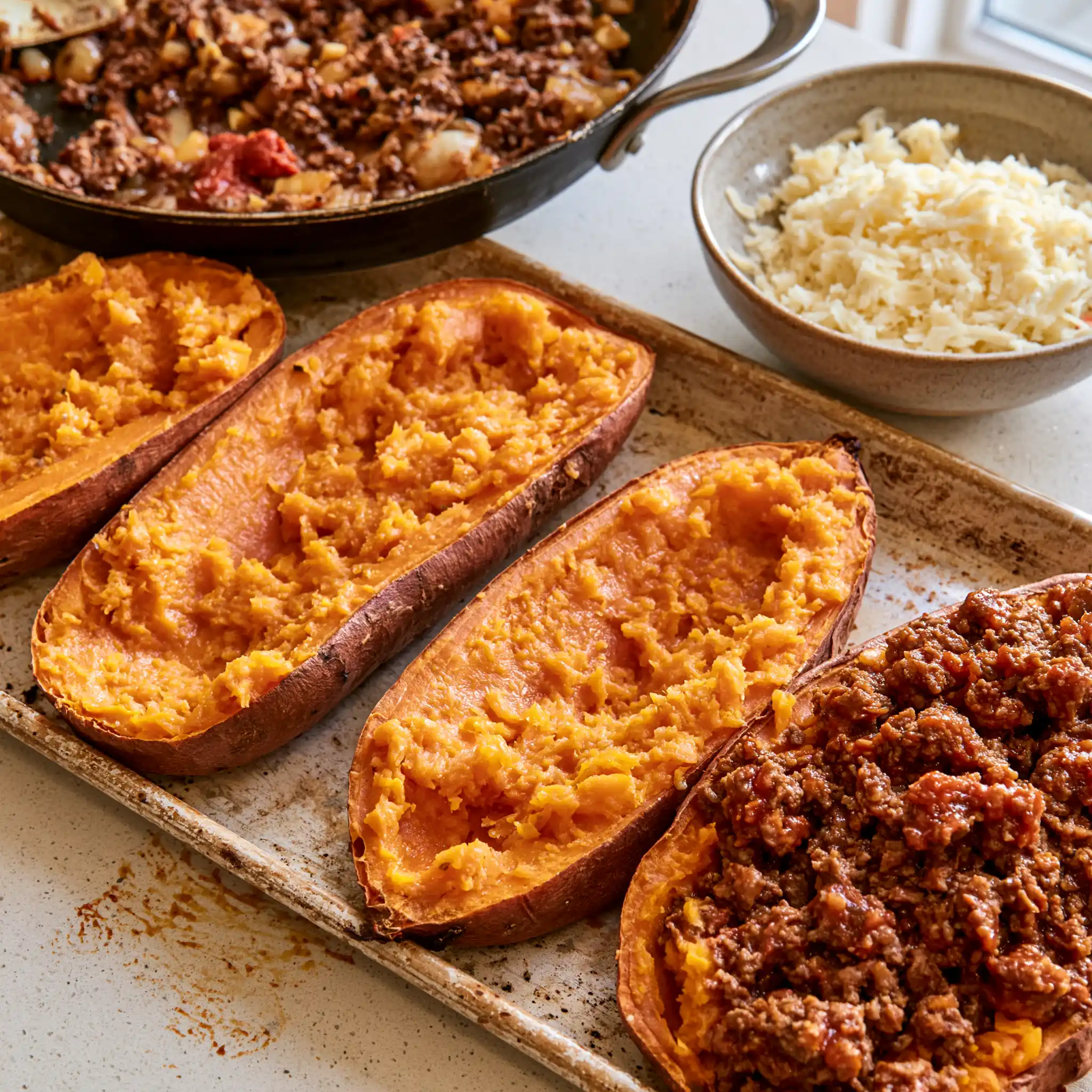 Ground beef, onion and bell pepper cooking in a skillet for stuffed sweet potatoes